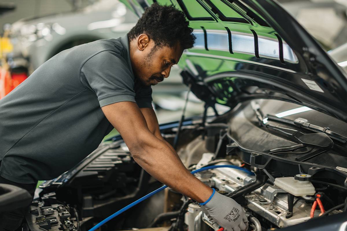 Technician inspecting an electric vehicle battery pack