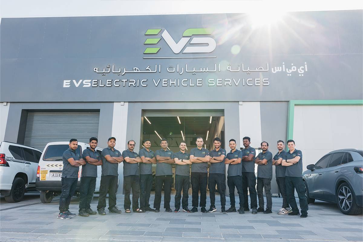 Certified technician performing maintenance on an electric vehicle at EVS UAE service center.